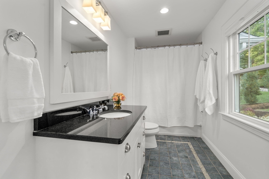 43 Bertwell Road Lexington, MA 02420 - Photo 17 of 37 a bathroom with a sink a toilet and a mirror