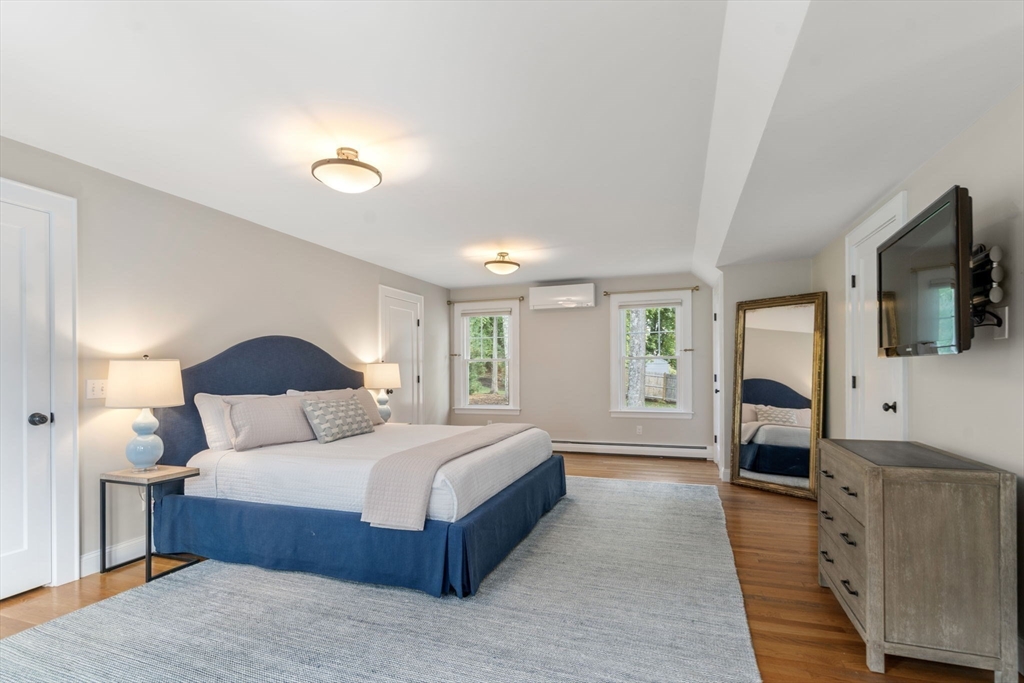 43 Bertwell Road Lexington, MA 02420 - Photo 20 of 37 a bedroom with a large bed and a flat tv screen on dresser