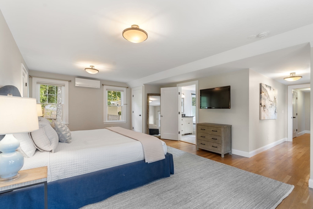 43 Bertwell Road Lexington, MA 02420 - Photo 21 of 37 a spacious bedroom with a bed and a flat screen tv