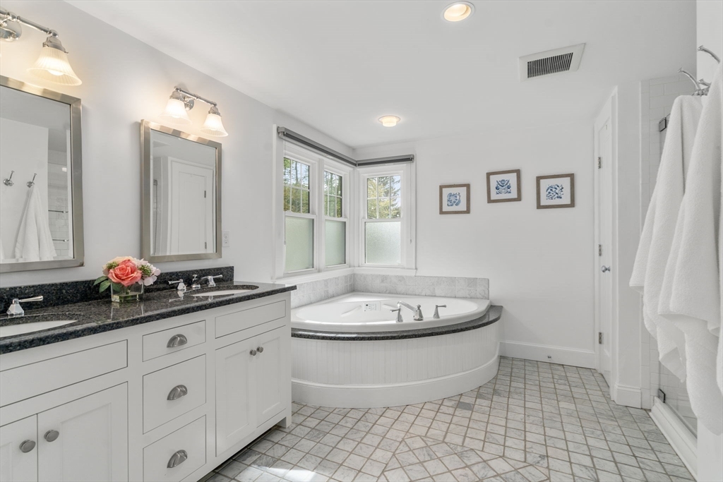 43 Bertwell Road Lexington, MA 02420 - Photo 23 of 37 a bathroom with a double vanity sink and a mirror