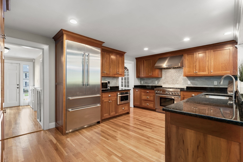 43 Bertwell Road Lexington, MA 02420 - Photo 7 of 37 a kitchen with granite countertop stainless steel appliances and wooden cabinets