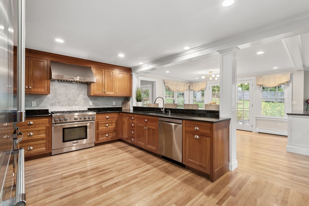 43 Bertwell Road Lexington, MA 02420 - Photo 8 of 37 a large kitchen with stainless steel appliances granite countertop a stove a sink and a wooden floors