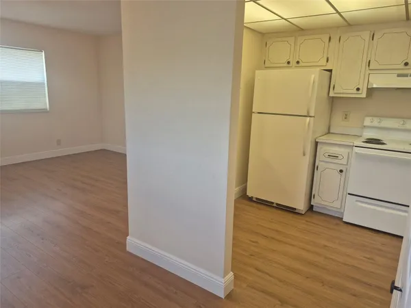 a view of a kitchen with wooden floor