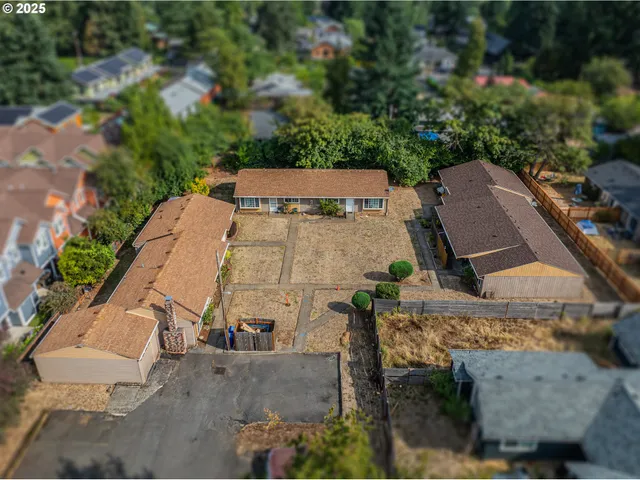 an aerial view of a house with a yard and trees