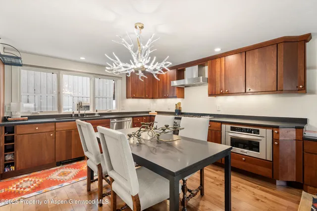 a kitchen with a table chairs sink and cabinets