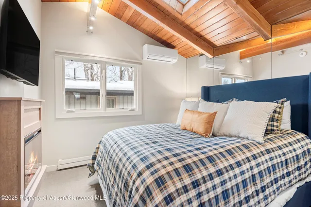 a bed sitting in a bedroom next to a window