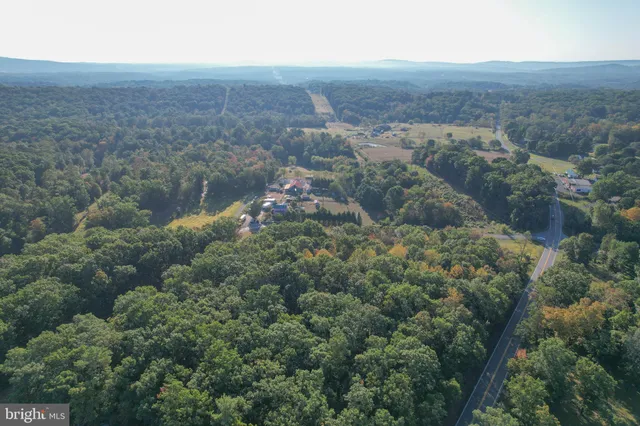 an aerial view of residential house and green space