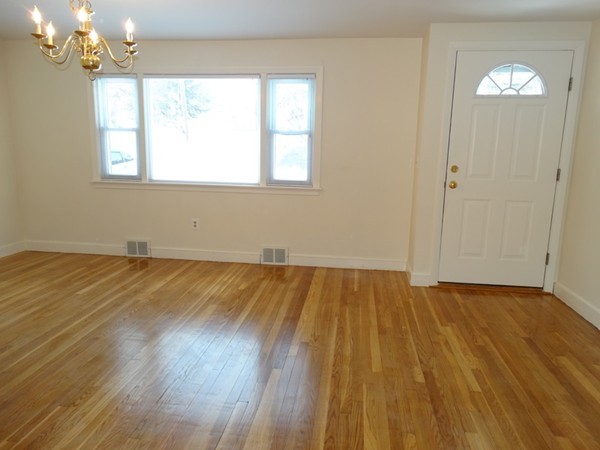 24 Holmes Road Ashland, MA 01721 - Photo 11 of 18 a view of a room with wooden floor and windows
