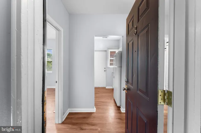 a view of hallway with wooden floor