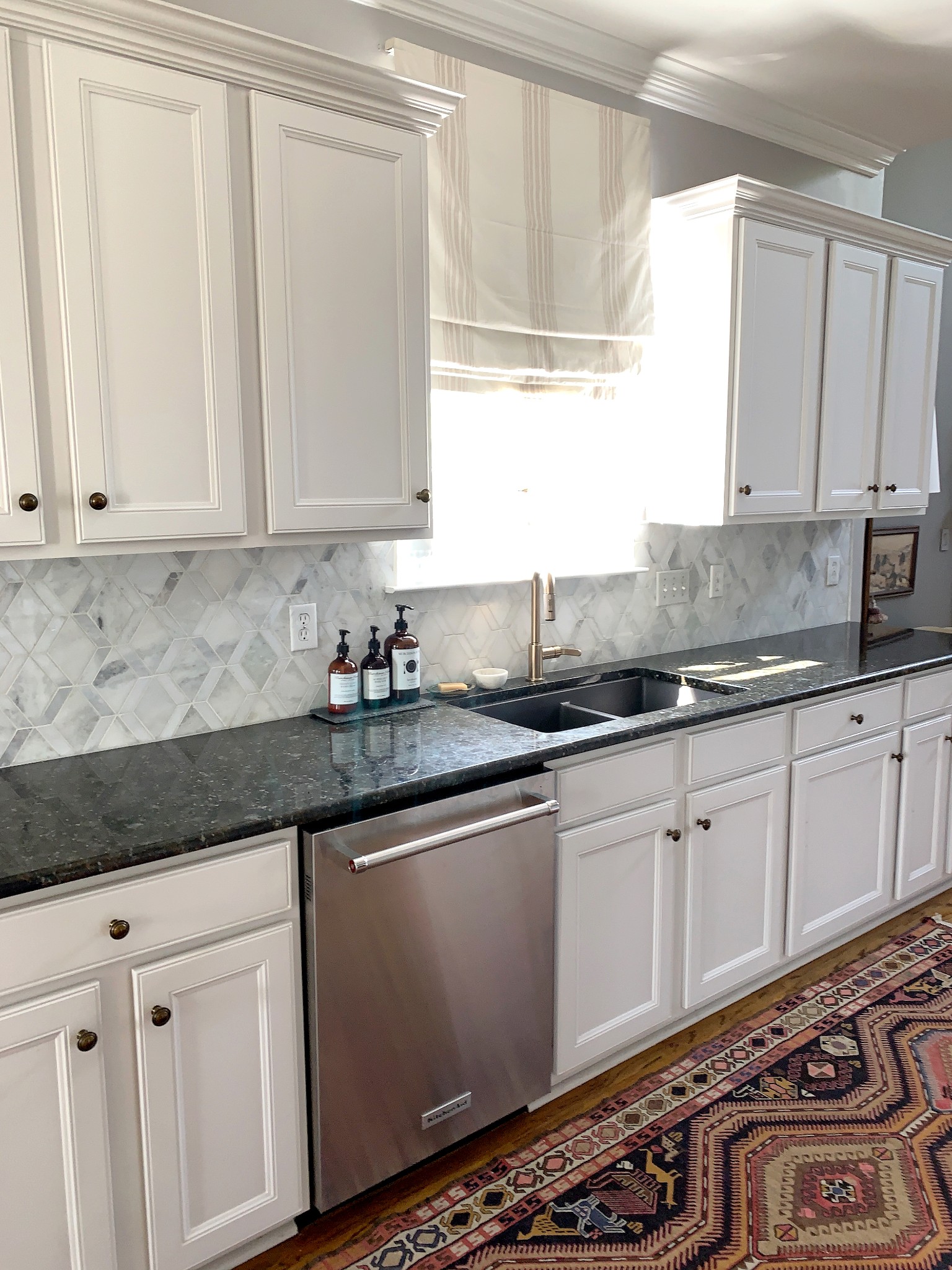 329 Wandering Circle Franklin, TN 37067 - Photo 6 of 23 a kitchen with granite countertop white cabinets and white appliances
