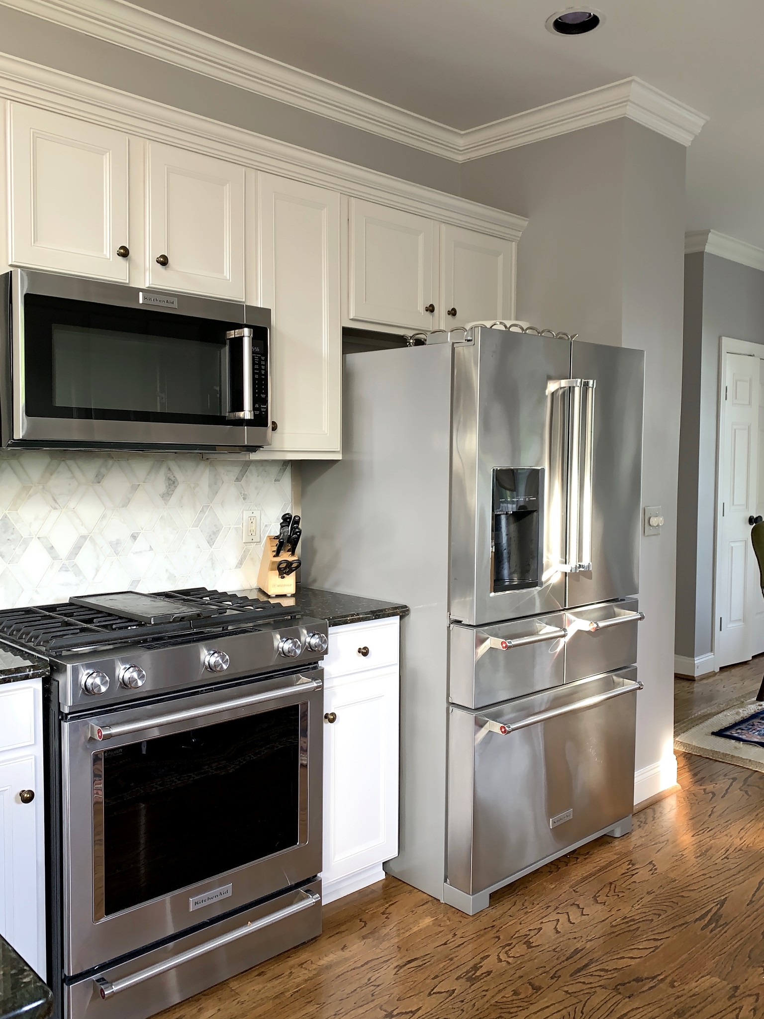 329 Wandering Circle Franklin, TN 37067 - Photo 7 of 23 a kitchen with stainless steel appliances granite countertop a stove a refrigerator and a microwave