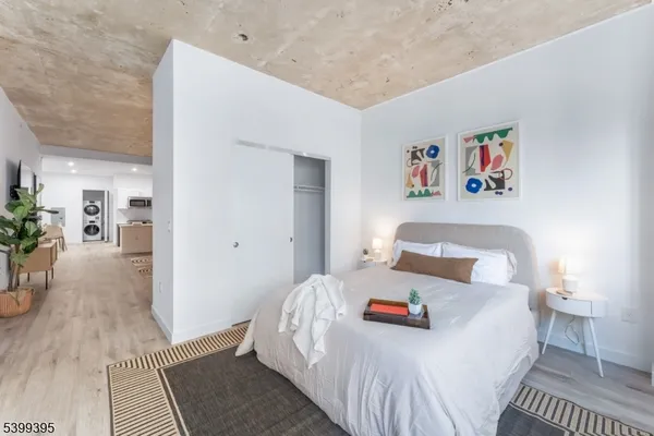 a bedroom with a bed and a painting on the wall