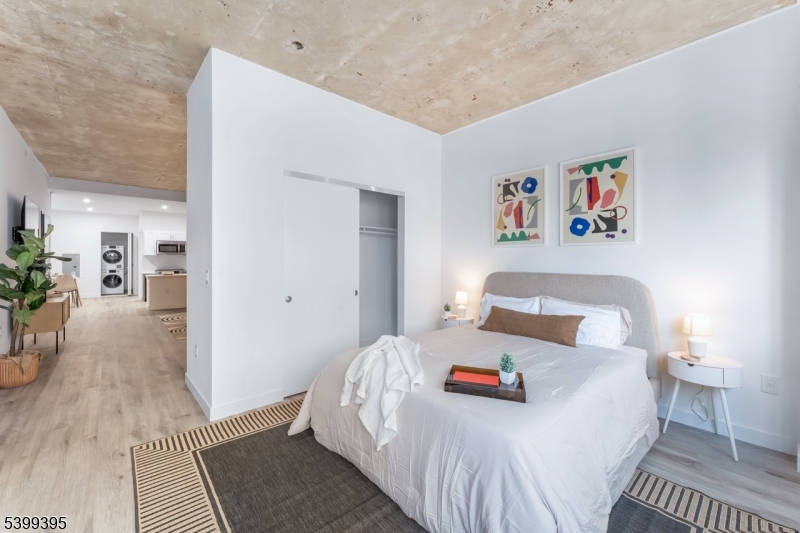 10 Commerce Court, Unit 2F Newark, NJ 07102 - Photo 12 of 18 a bedroom with a bed and a painting on the wall