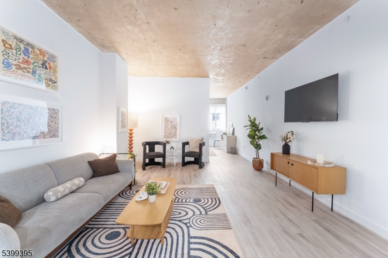 10 Commerce Court, Unit 2F Newark, NJ 07102 - Photo 14 of 18 a living room with furniture and a flat screen tv