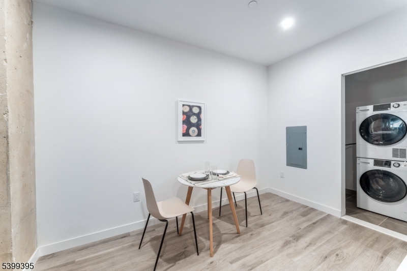 10 Commerce Court, Unit 2F Newark, NJ 07102 - Photo 3 of 18 a view of a dining room with furniture and wooden floor