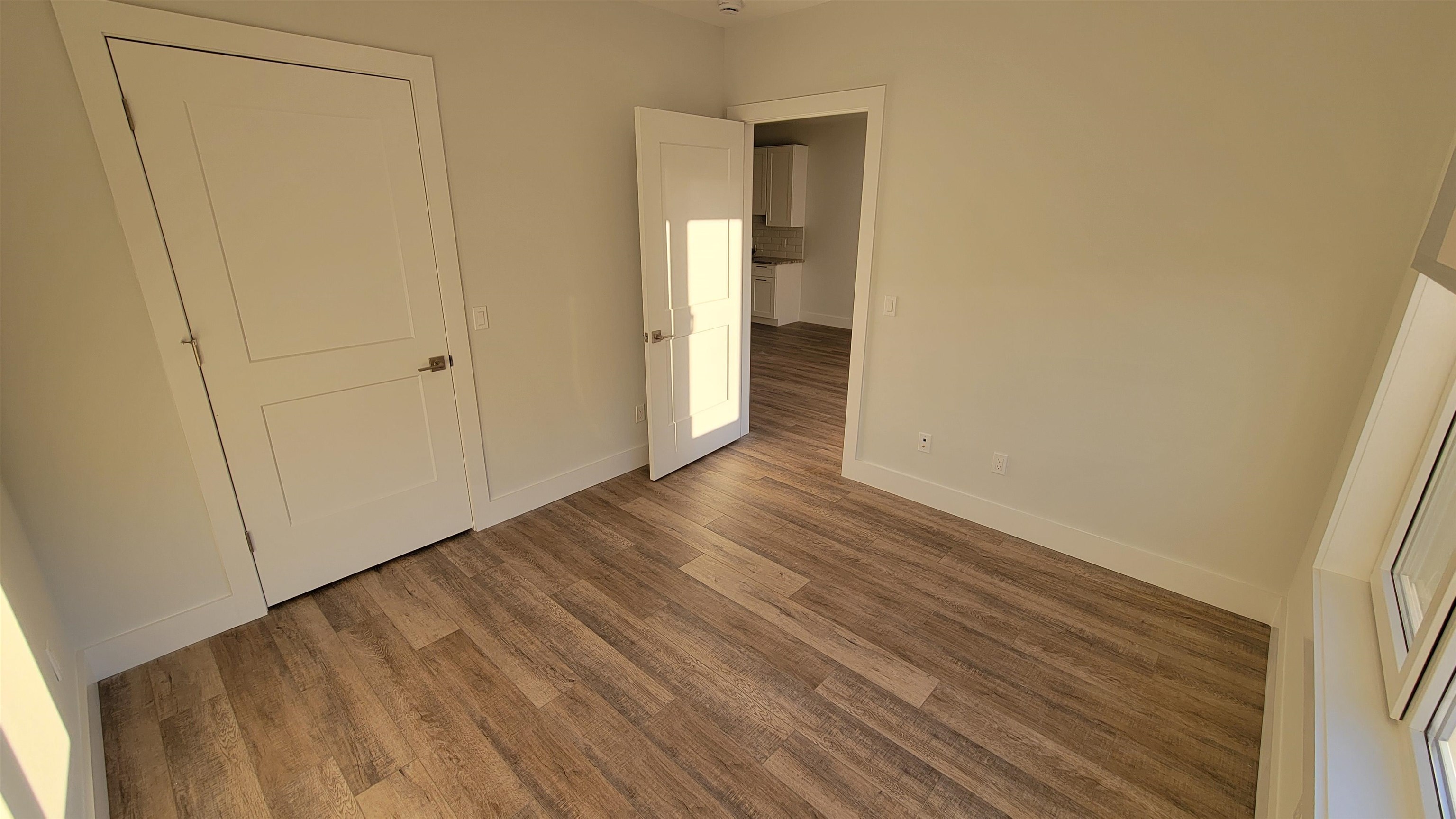228 Park Avenue, Unit 305 East Rutherford, NJ 07073 - Photo 7 of 11 a view of an empty room with wooden floor