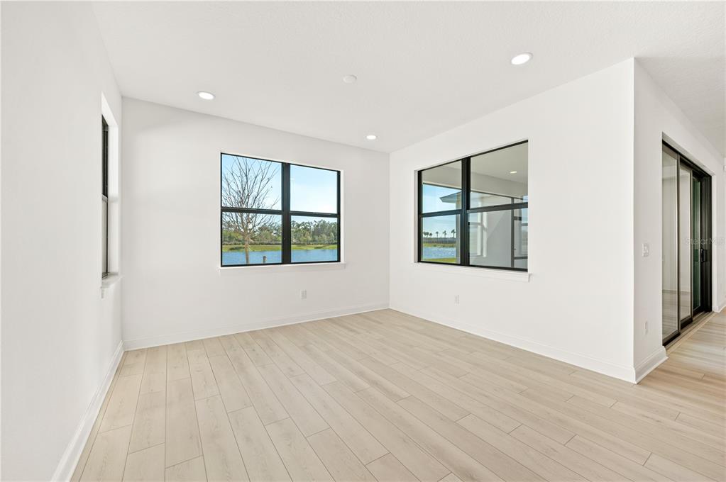 5830 Freestone Circle Apollo Beach, FL 33572 - Photo 13 of 34 an empty room with wooden floor and windows