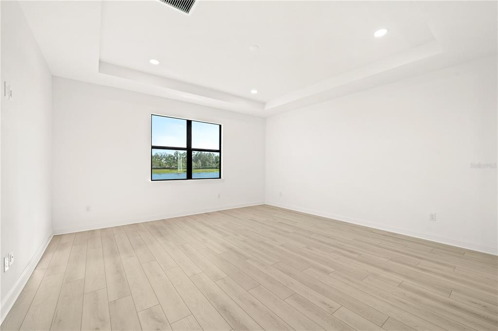 5830 Freestone Circle Apollo Beach, FL 33572 - Photo 17 of 34 an empty room with wooden floor and window