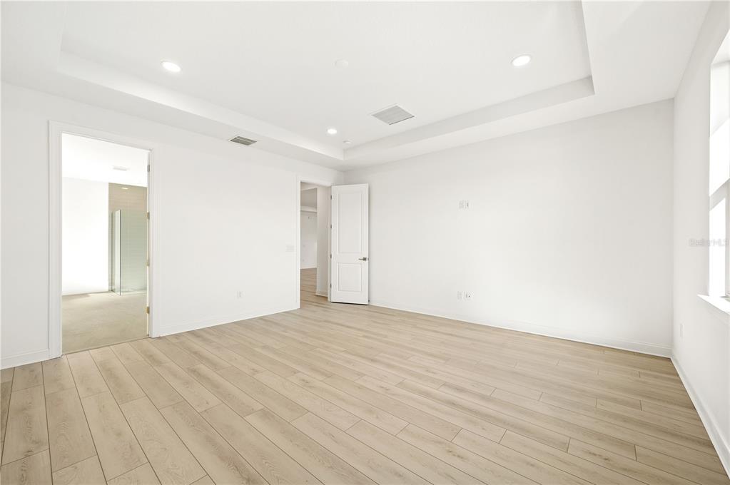 5830 Freestone Circle Apollo Beach, FL 33572 - Photo 18 of 34 a view of an empty room with wooden floor and a window