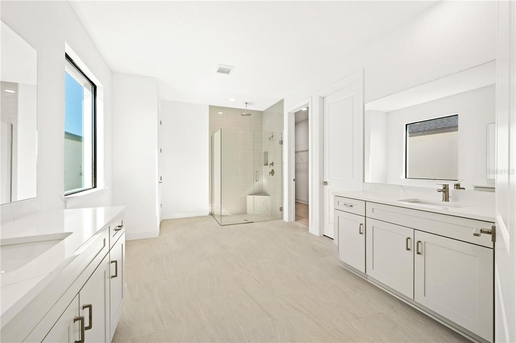 5830 Freestone Circle Apollo Beach, FL 33572 - Photo 19 of 34 a spacious bathroom with a double vanity sink a mirror and a shower