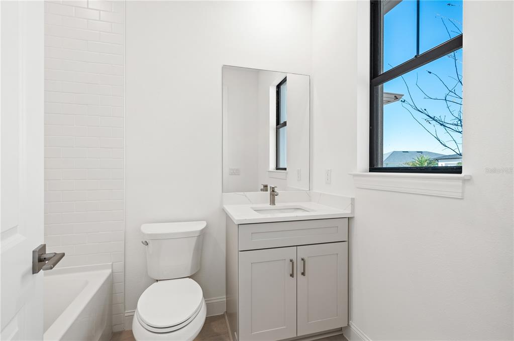 5830 Freestone Circle Apollo Beach, FL 33572 - Photo 28 of 34 a bathroom with a toilet a sink and mirror