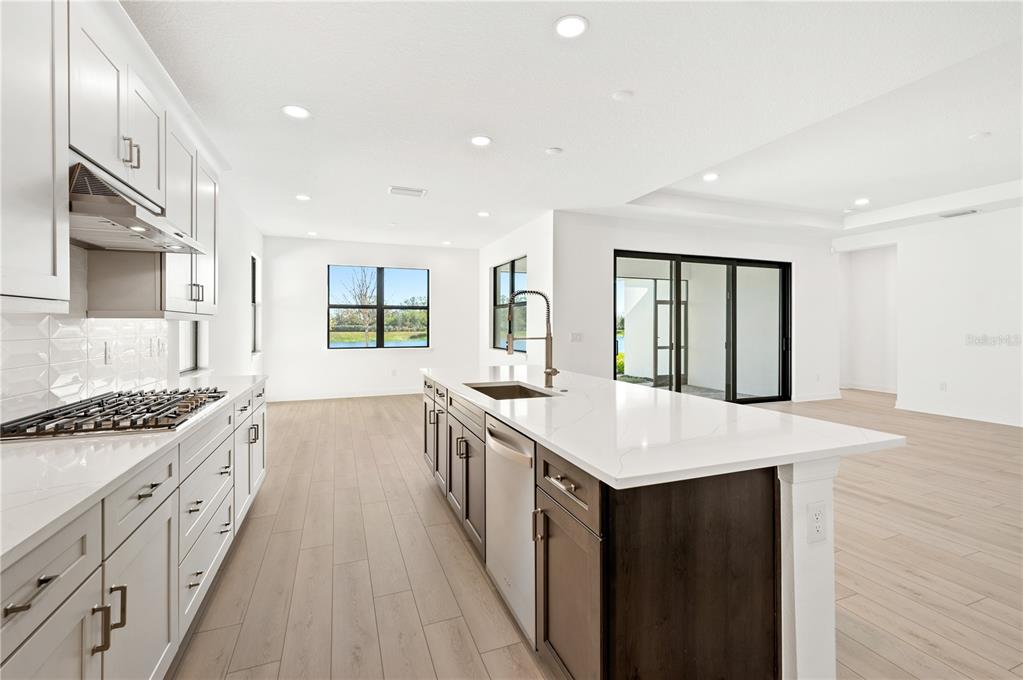 5830 Freestone Circle Apollo Beach, FL 33572 - Photo 8 of 34 a large kitchen with stainless steel appliances granite countertop a stove and a sink