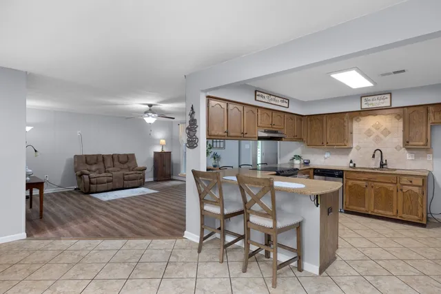 a kitchen with microwave a sink and cabinets