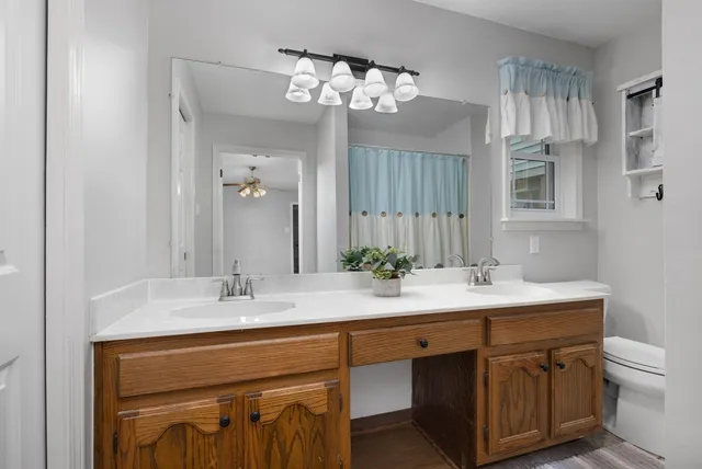 a bathroom with a sink a light fixture and a mirror
