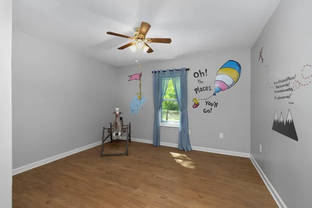 a view of room with gym equipment and a window