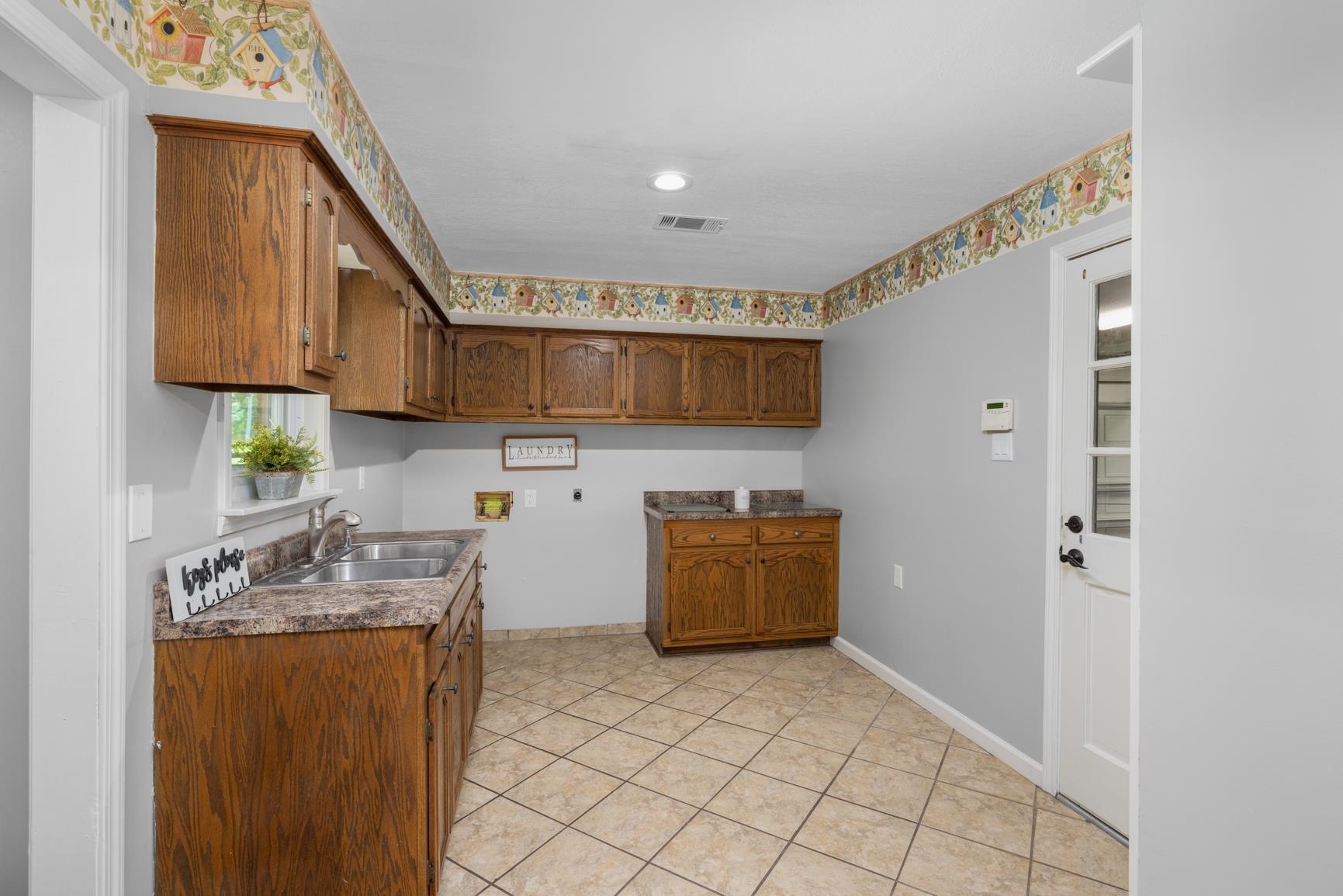 6639 Old Millington Road Millington, TN 38053 - Photo 31 of 40 Just off the kitchen, a separate laundry room with plenty of storage that leads into the spacious 2 car garage with large storage closet.