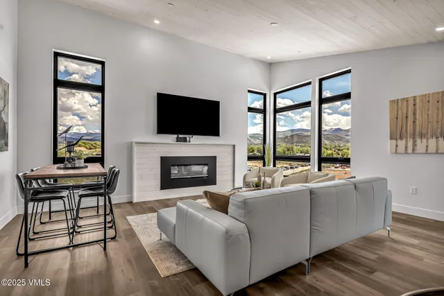 a living room with fireplace furniture and a flat screen tv