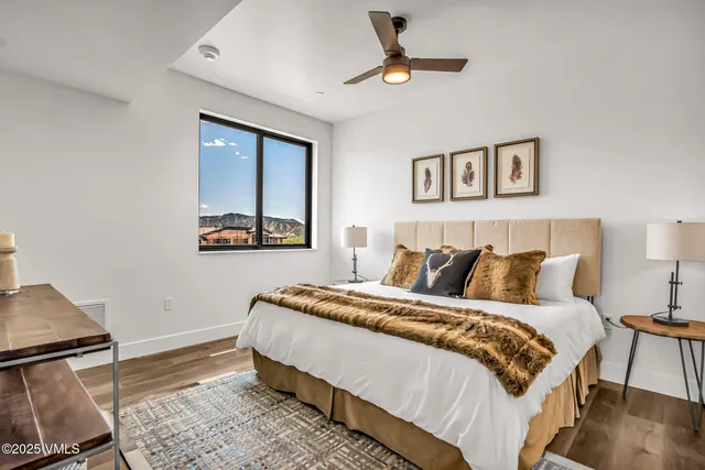 a bedroom with a large bed and a chandelier