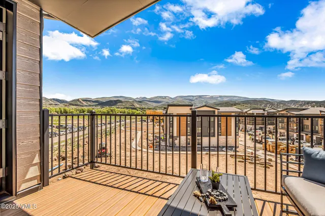 a view of a balcony with wooden floor and city view
