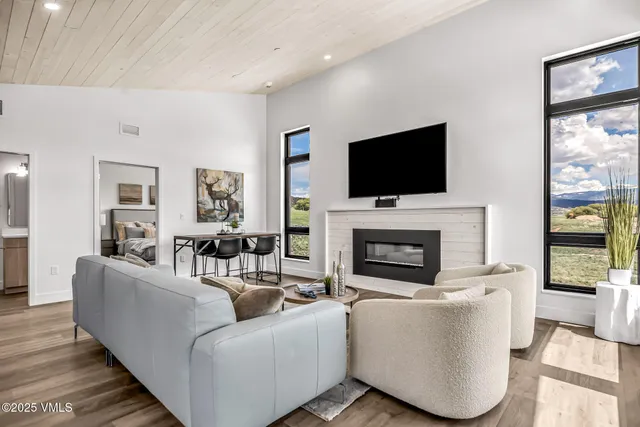 a living room with fireplace furniture and a flat screen tv