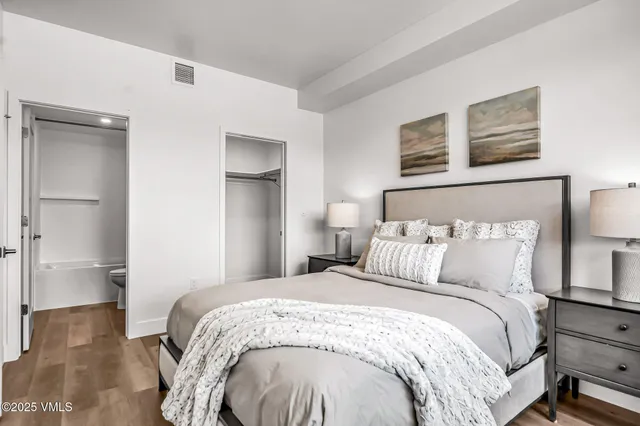 a bedroom with a bed and a lamp