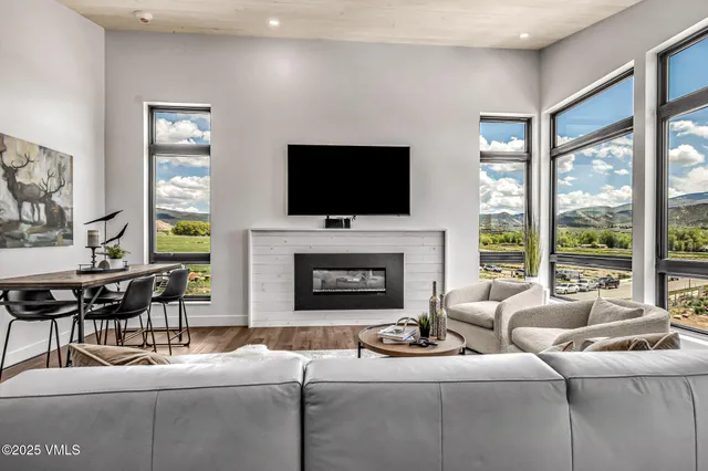 a living room with fireplace furniture and a flat screen tv