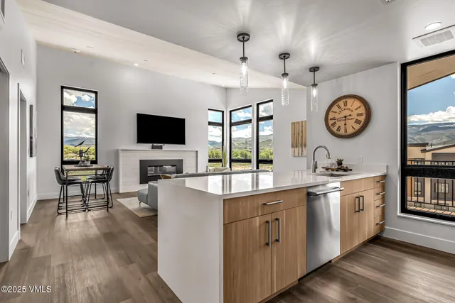 a open hall with wooden floor and a sink