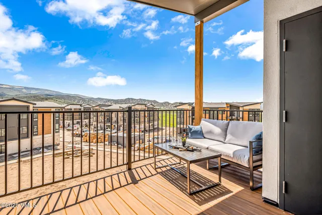 a balcony with wooden floor and city view