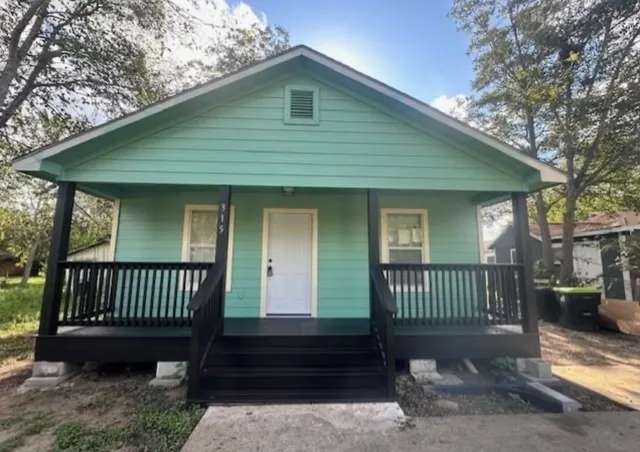 a view of a house with a yard and deck