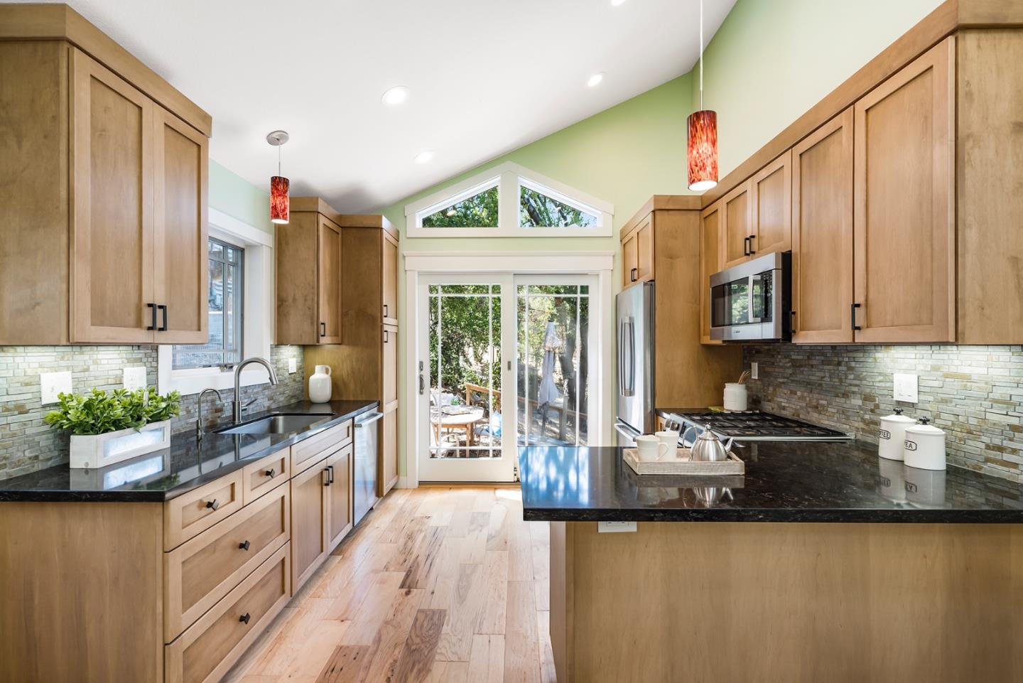 1975 Cordilleras Road Redwood City, CA 94062 - Photo 9 of 39 a kitchen with sink a counter top space cabinets and stainless steel appliances
