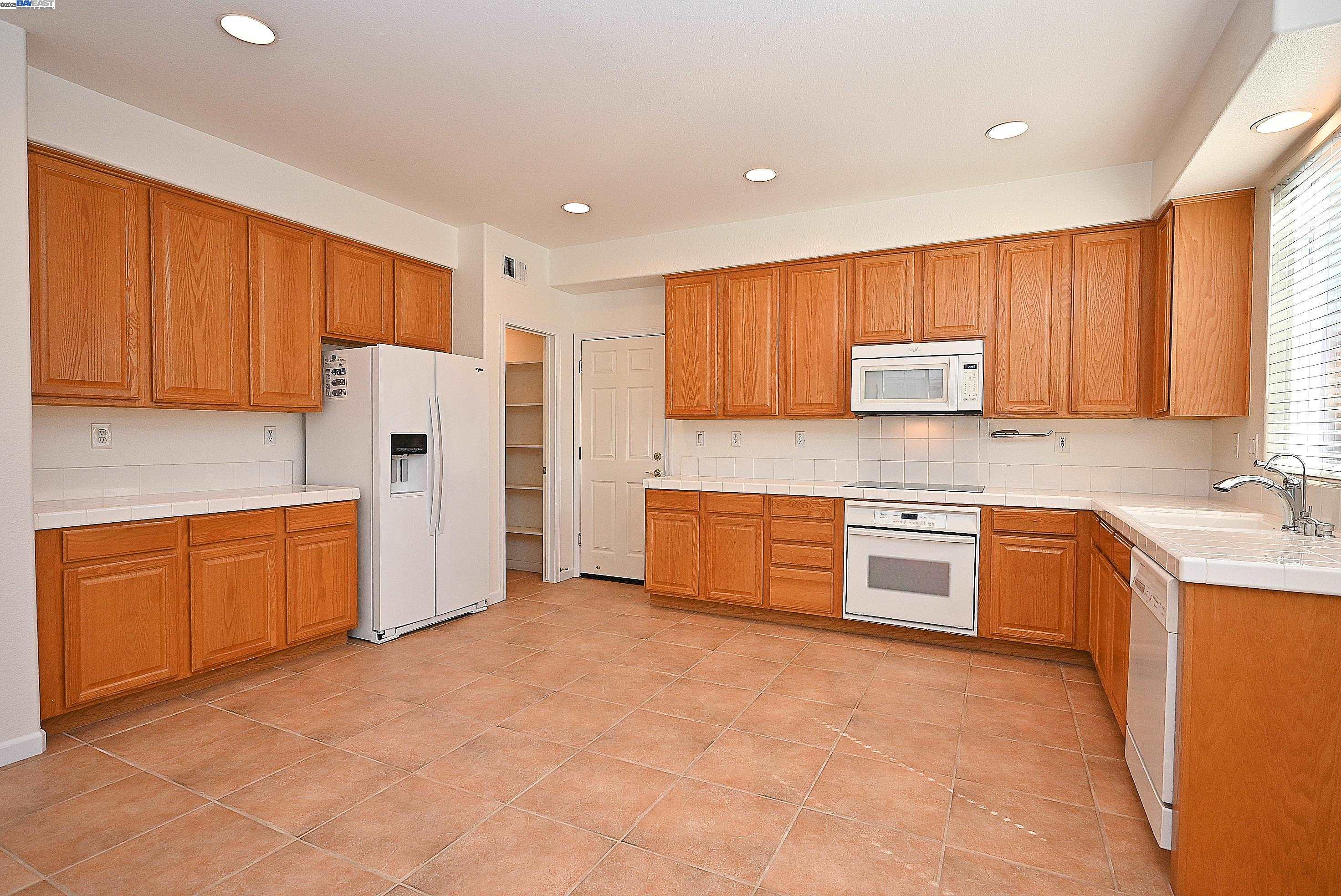 4189 Tessa Place Pleasanton, CA 94566 - Photo 14 of 41 a kitchen with stainless steel appliances granite countertop a refrigerator sink and stove