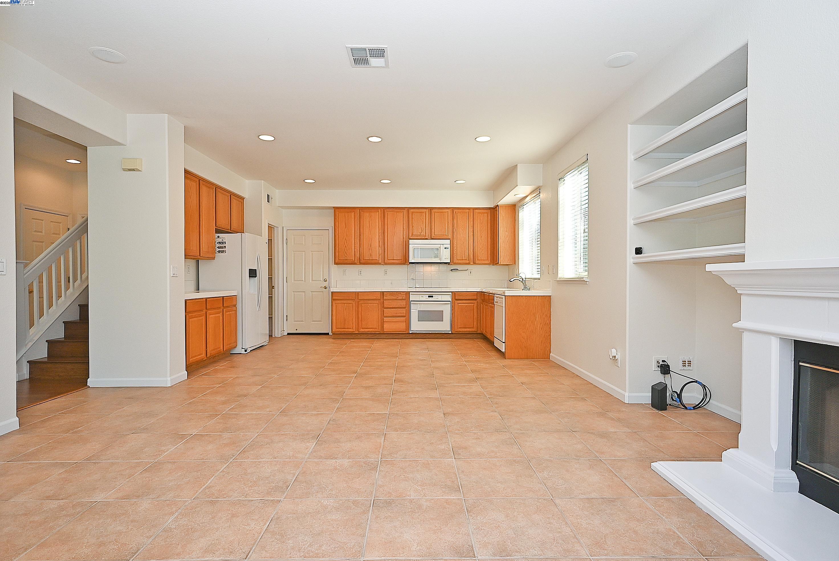 4189 Tessa Place Pleasanton, CA 94566 - Photo 16 of 41 a view of a kitchen with a sink and a refrigerator