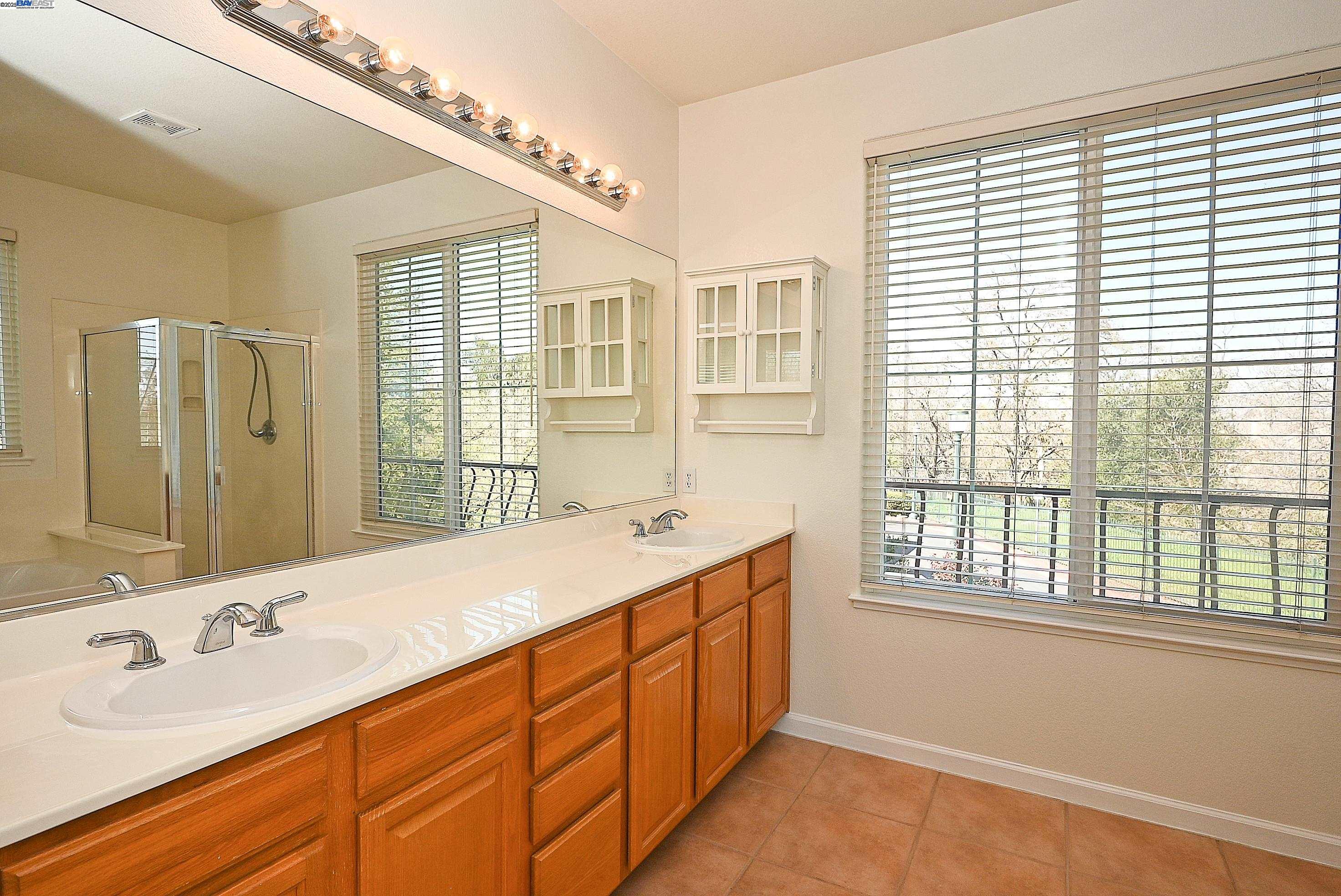 4189 Tessa Place Pleasanton, CA 94566 - Photo 22 of 41 a bathroom with a double vanity sink and a mirror