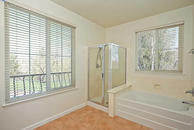 a bathroom with a bathtub and a shower