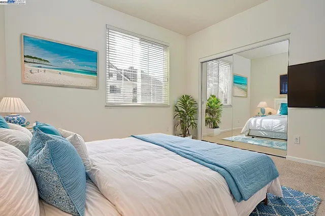 a bedroom with a bed and flat screen tv