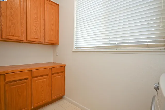 a close view of white cabinets and a window