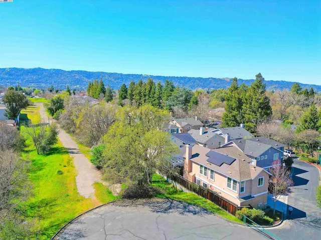 a view of backyard with table and chairs