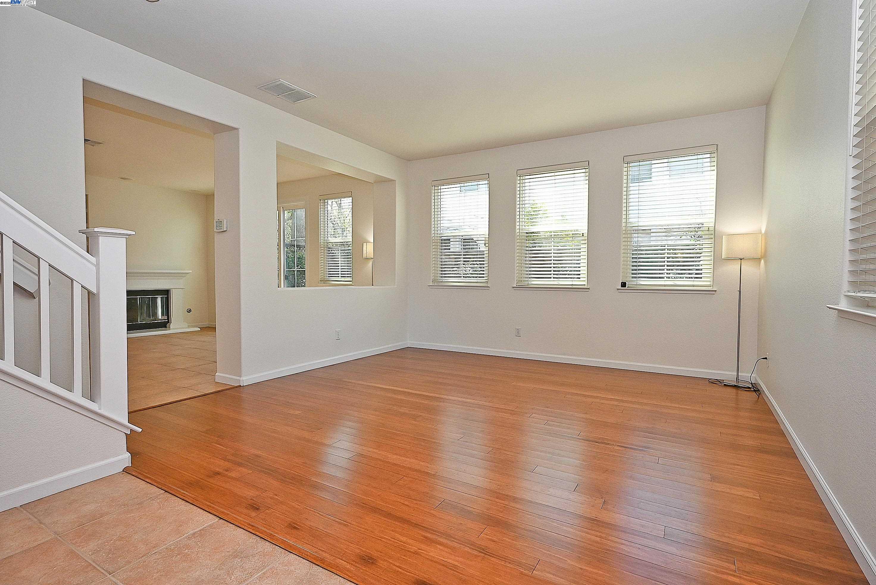4189 Tessa Place Pleasanton, CA 94566 - Photo 4 of 41 a view of an empty room with wooden floor and a window