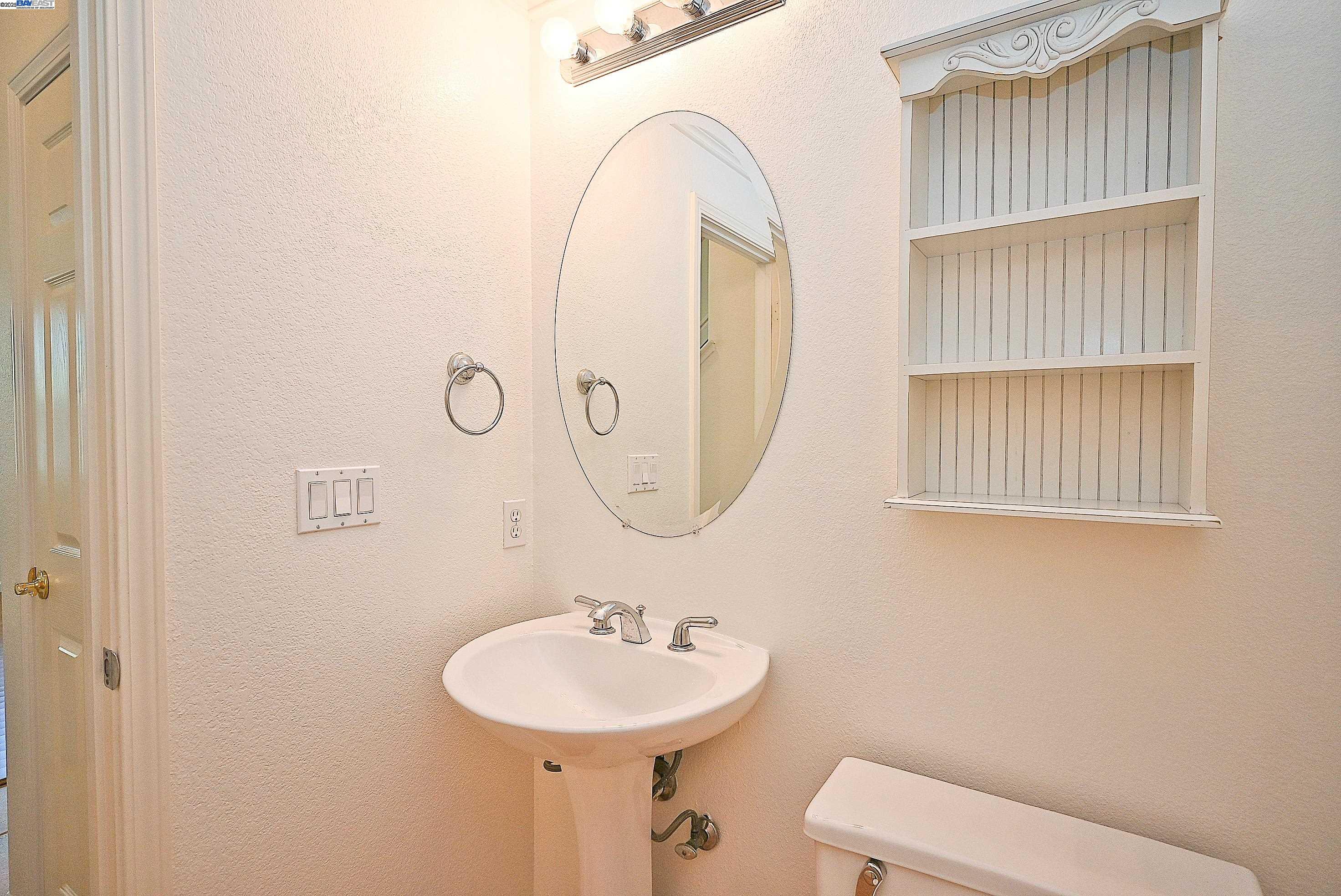 4189 Tessa Place Pleasanton, CA 94566 - Photo 7 of 41 a bathroom with a sink a toilet and a mirror