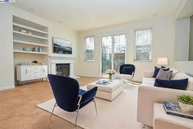 a living room with furniture fireplace and a window
